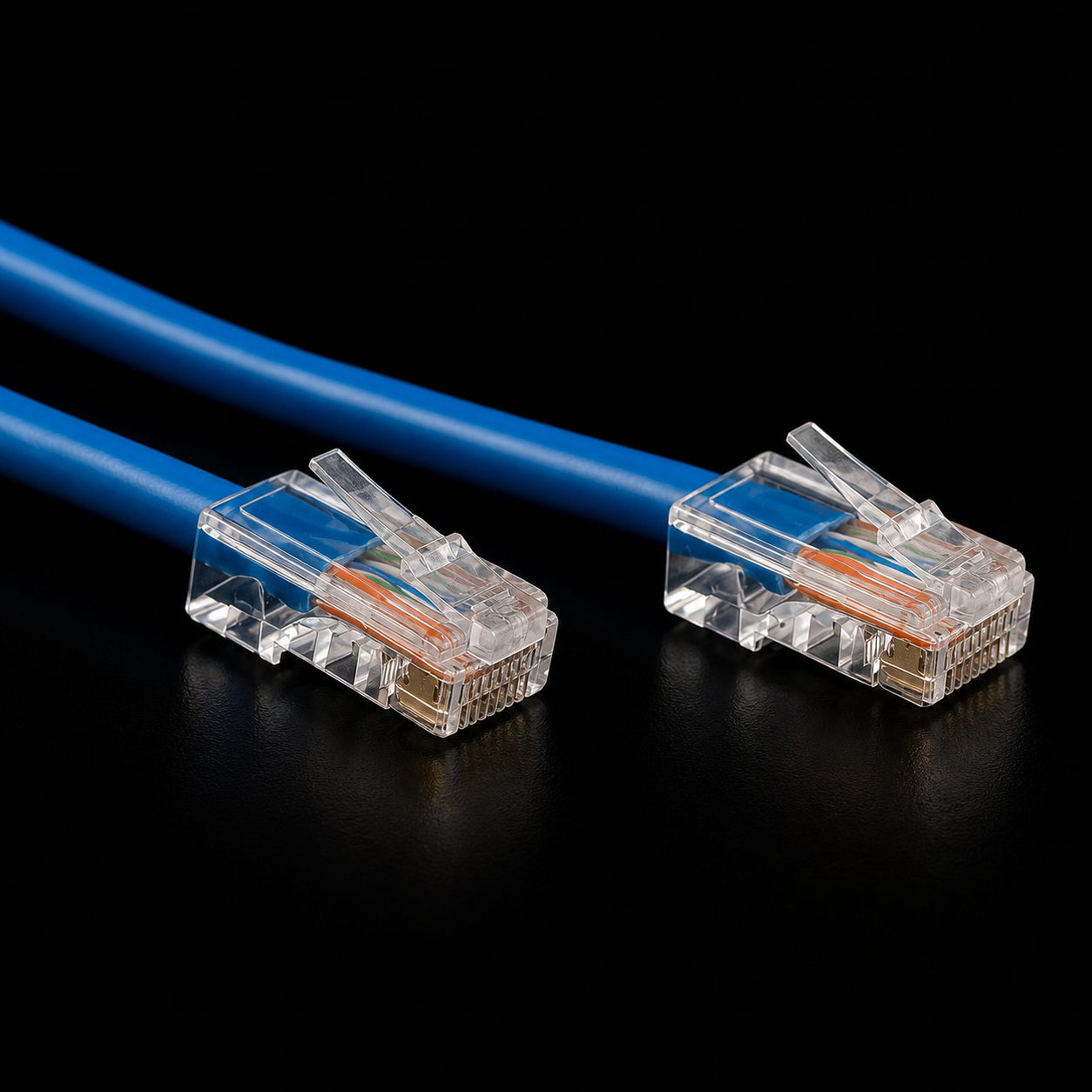 Close-up Ethernet RJ45 connectors on a black surface.